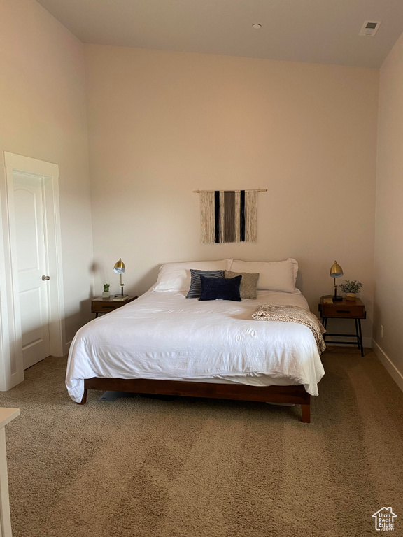 Bedroom featuring carpet and baseboards