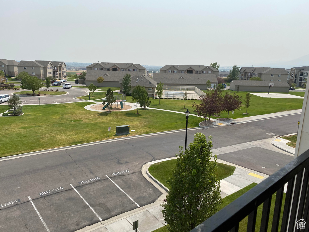 View of asphalt street with a residential view and curbs