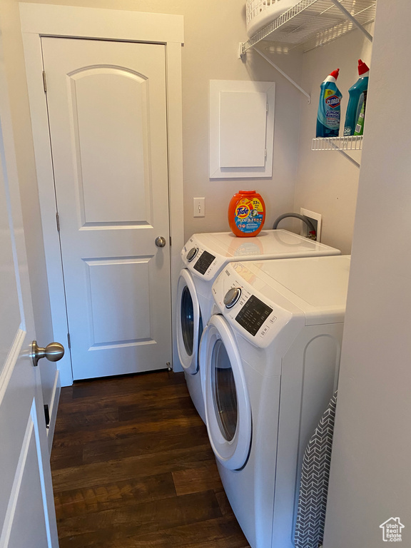 Laundry area featuring separate washer and dryer and dark wood finished floors