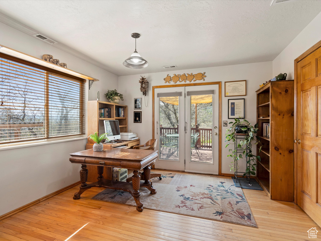 Office area featuring light wood-type flooring and baseboards