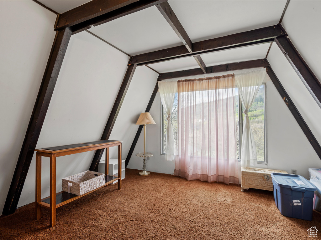 Bonus room with carpet floors and beamed ceiling