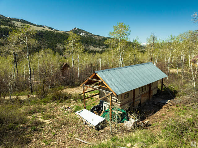 View of outbuilding featuring a mountain view and a wooded view