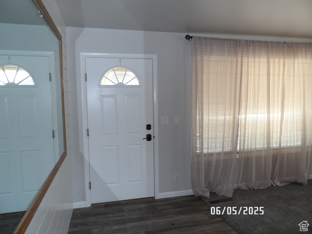 Entrance foyer featuring dark wood-style floors and baseboards