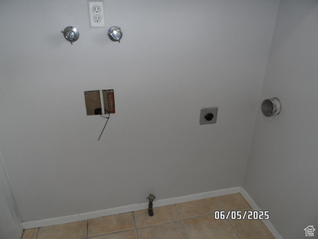 Washroom featuring baseboards, tile patterned flooring, and electric dryer hookup
