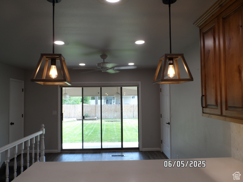 Kitchen featuring baseboards, dark wood finished floors, ceiling fan, recessed lighting, and decorative light fixtures