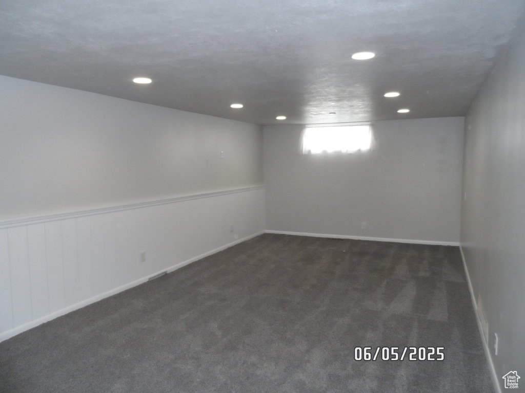 Basement with dark carpet and recessed lighting