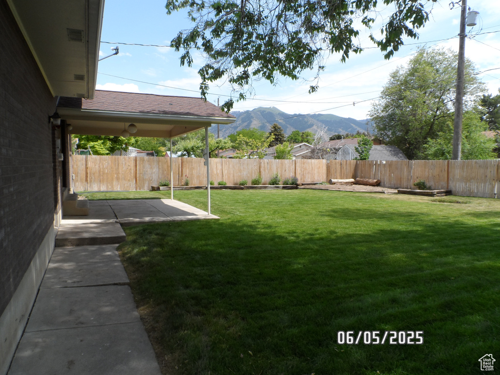 View of yard featuring a mountain view and a patio area