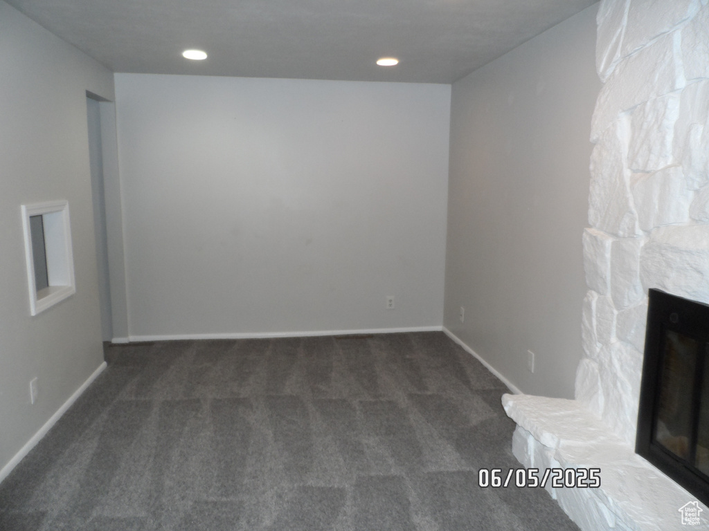 Unfurnished living room with carpet floors, baseboards, and recessed lighting