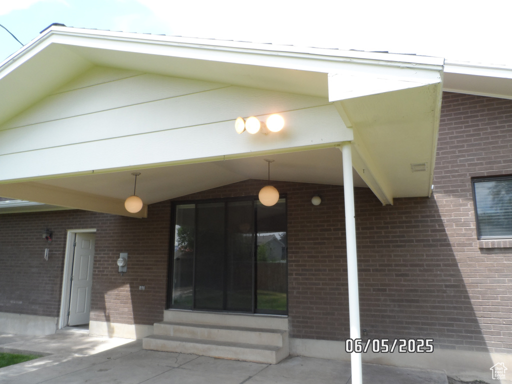 Property entrance featuring brick siding