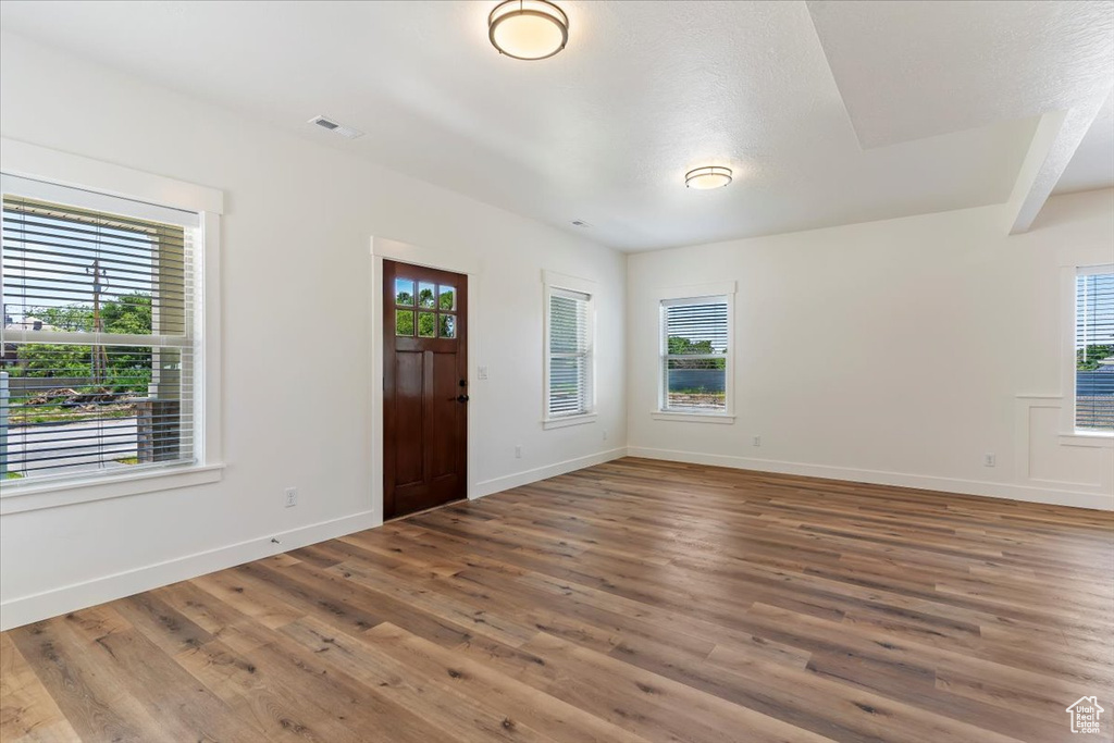 Entryway with wood finished floors, plenty of natural light, and baseboards