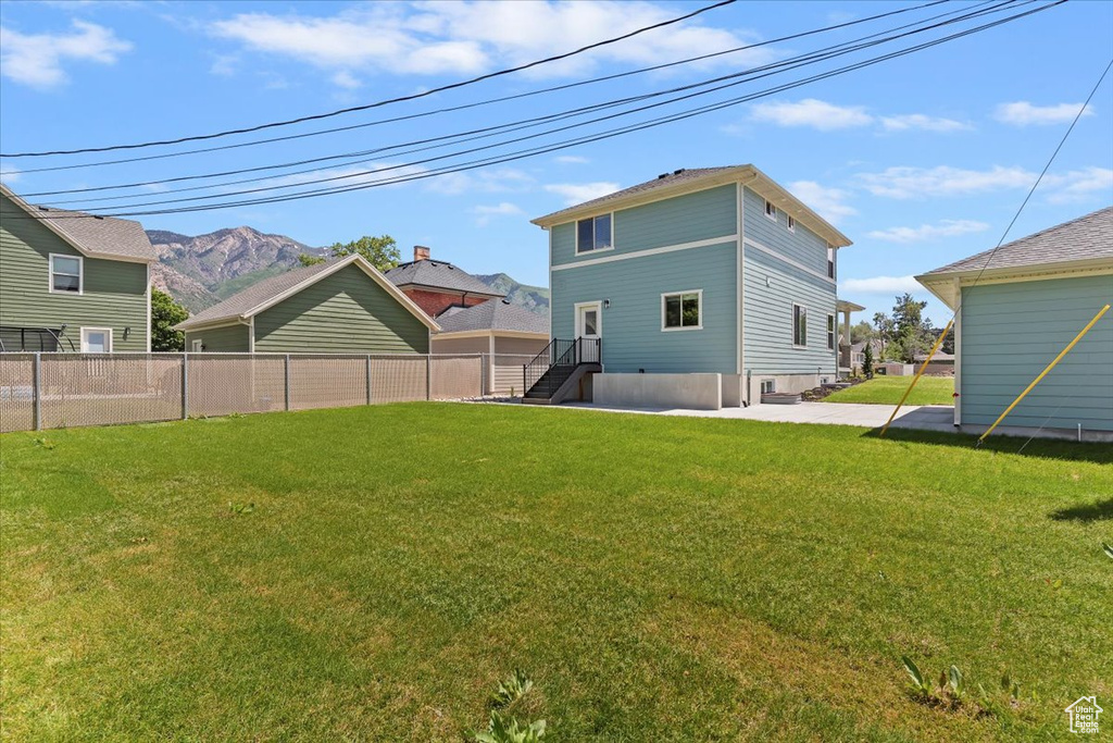 Back of property with a mountain view