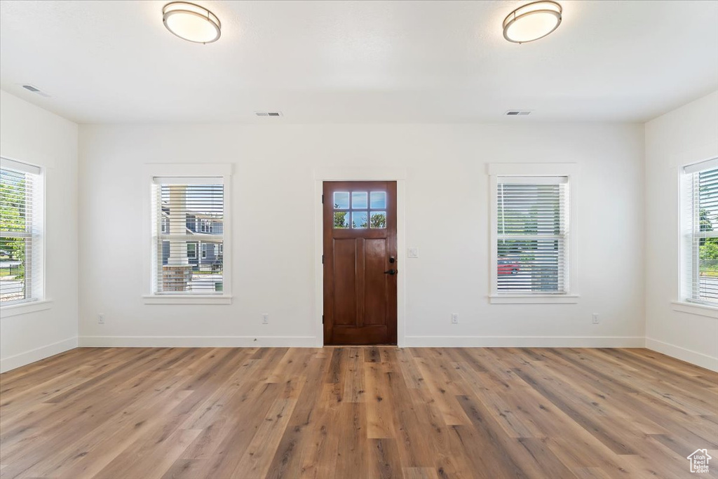 Entryway with light wood-style floors and baseboards