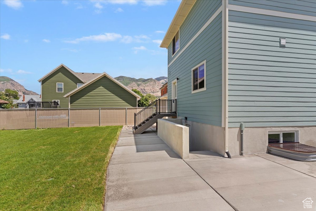 View of yard with a mountain view and a patio