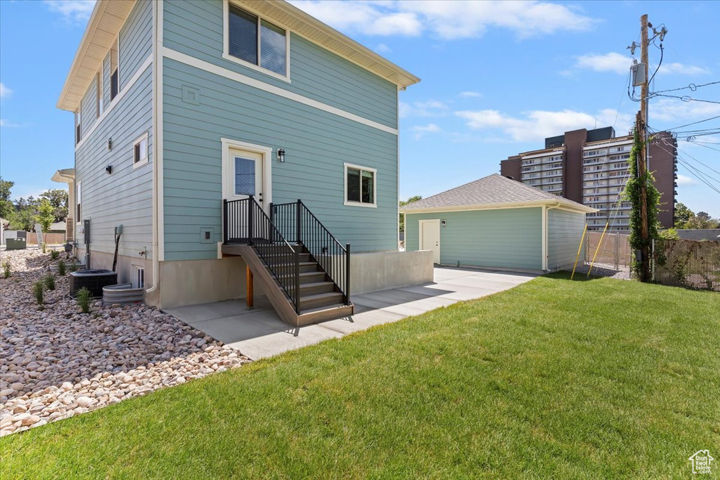 Back of property featuring central AC and a patio