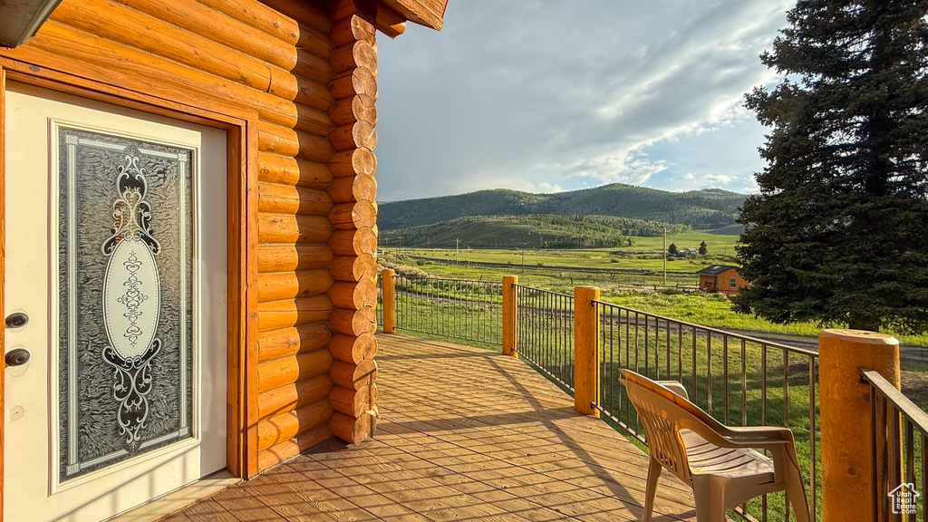 Deck with a view of countryside and a mountain view