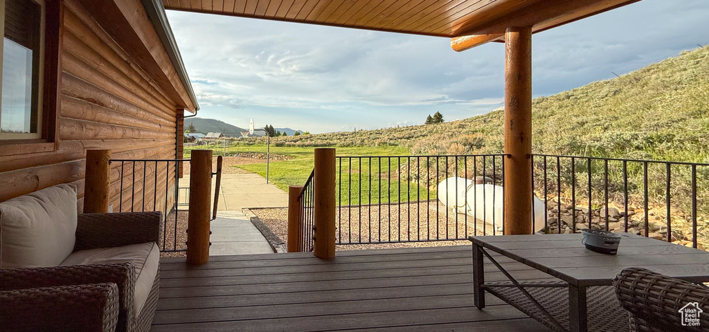 Wooden deck with a mountain view and a rural view
