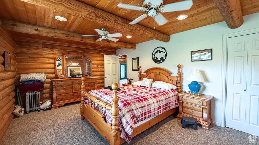 Bedroom with wooden ceiling with exposed beams, light colored carpet, recessed lighting, rustic walls, and a ceiling fan