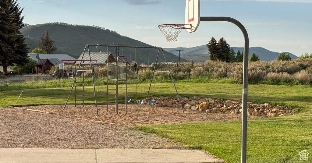 View of sport court featuring a yard and a mountain view