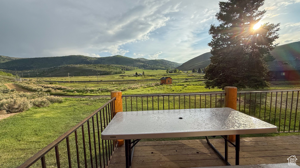 Deck with a view of countryside and a mountain view