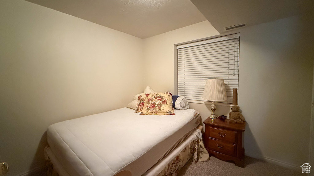 Carpeted bedroom with baseboards