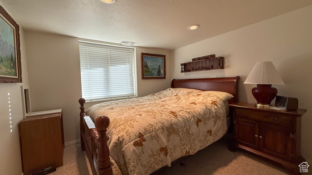 Carpeted bedroom with recessed lighting