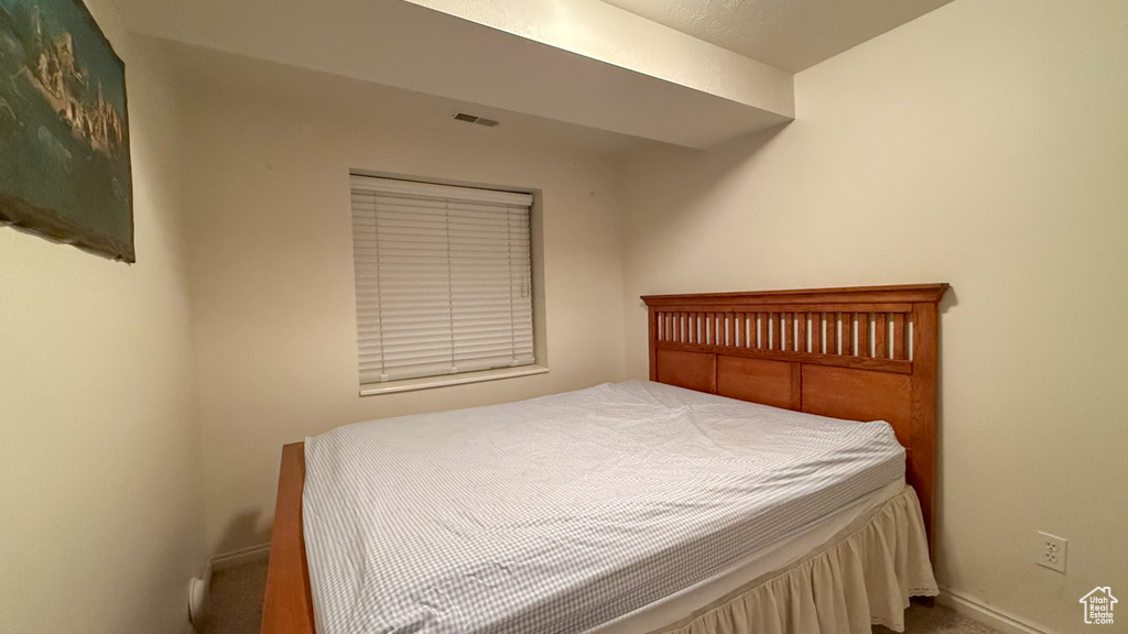 Carpeted bedroom featuring baseboards
