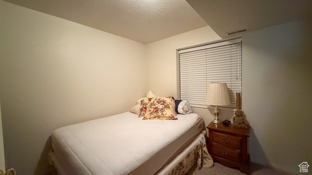 Carpeted bedroom with baseboards
