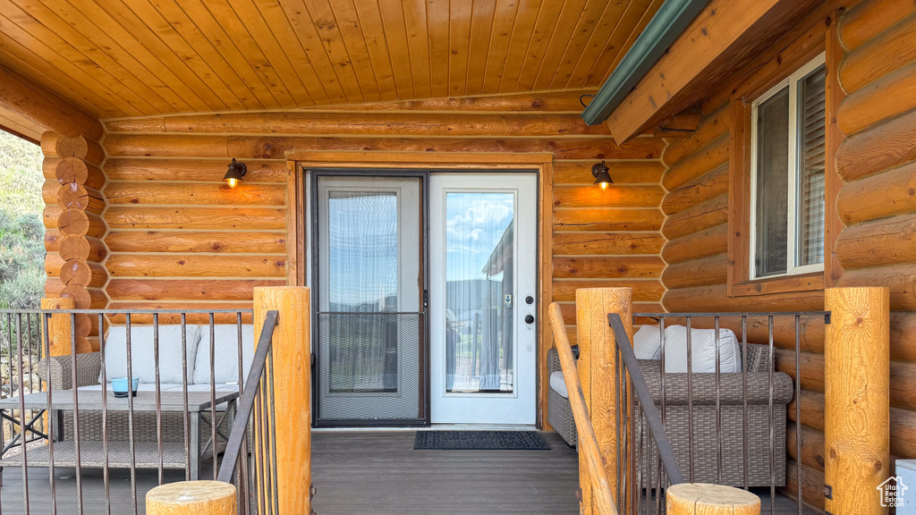 Property entrance featuring log siding