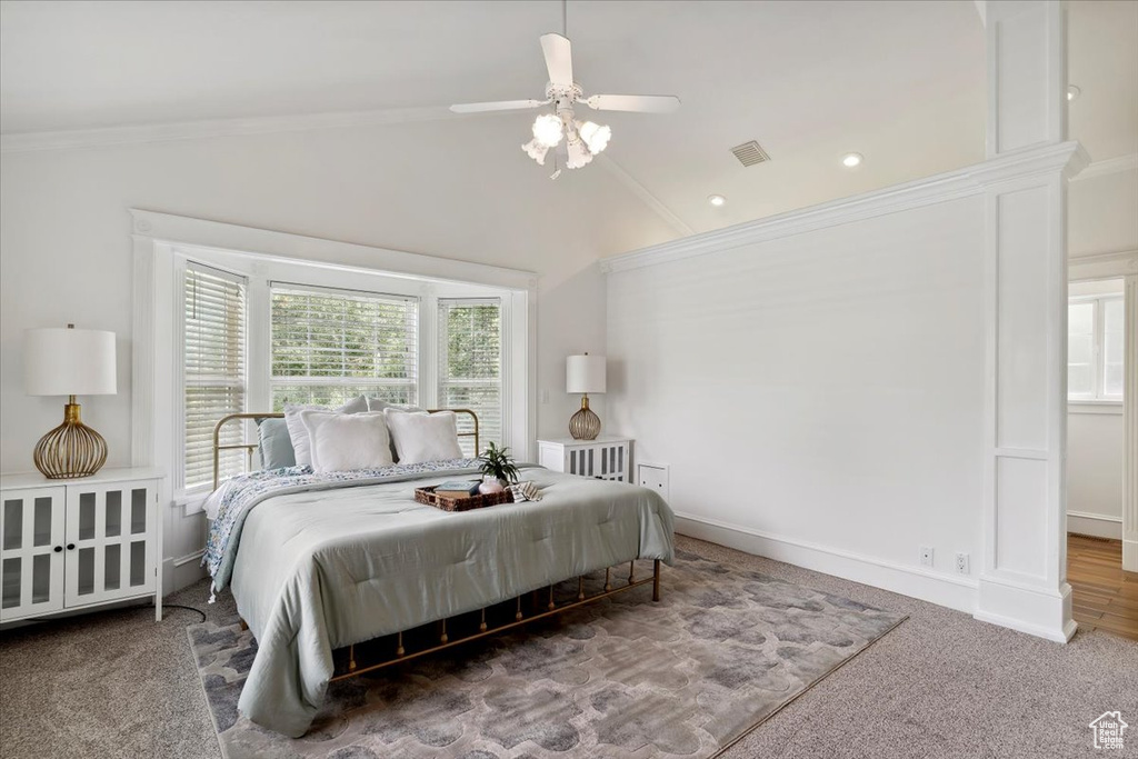 Bedroom featuring vaulted ceiling, crown molding, carpet flooring, a ceiling fan, and recessed lighting