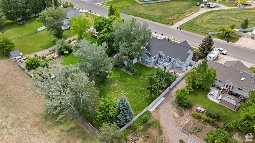 Aerial view of property and surrounding area featuring nearby suburban area