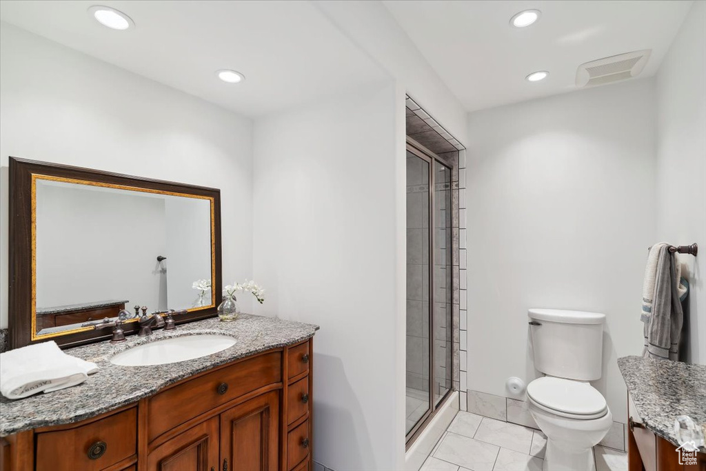 Bathroom featuring vanity, toilet, a shower stall, and recessed lighting