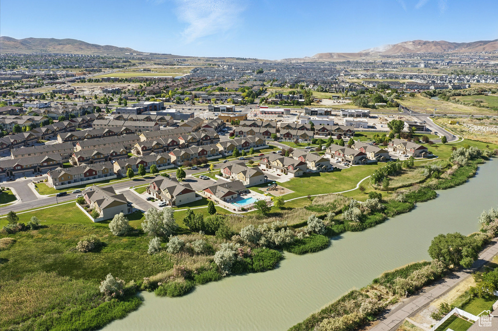 Aerial view of property's location featuring a water and mountain view and nearby suburban area