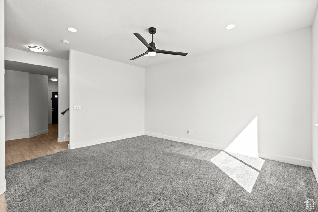 Carpeted empty room with ceiling fan, recessed lighting, baseboards, and a smoke detector