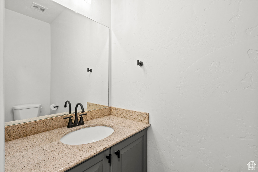 Half bath with vanity and toilet