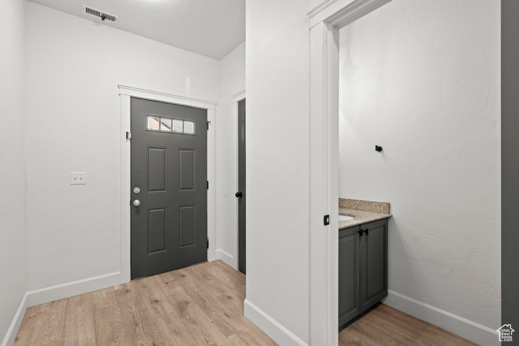 Entryway featuring light wood-type flooring and baseboards