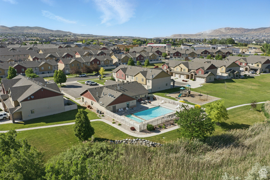 Aerial view of residential area featuring a pool area and a mountain backdrop