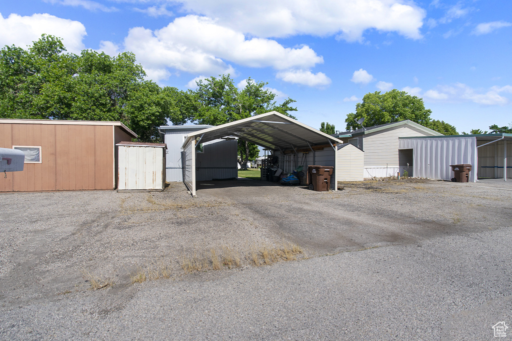 View of car parking featuring driveway and a carport