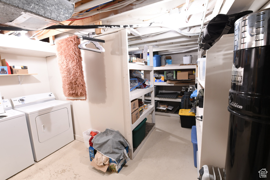 Unfinished below grade area with washing machine and clothes dryer
