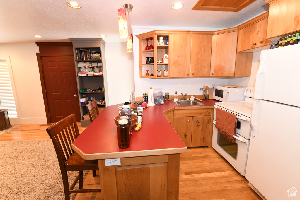 Kitchen with white appliances, a sink, open shelves, recessed lighting, and light wood-type flooring
