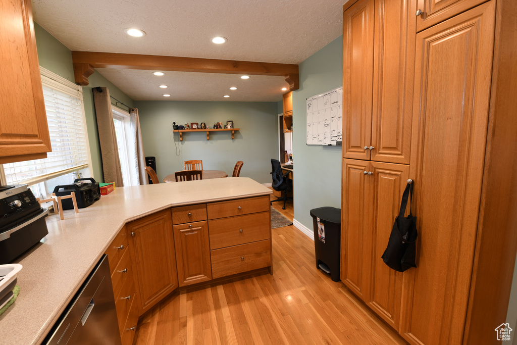 Kitchen with stainless steel dishwasher, light wood-style floors, a peninsula, recessed lighting, and brown cabinetry