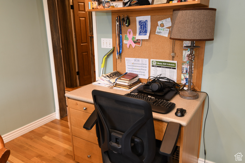 Office area featuring baseboards and light wood-style floors