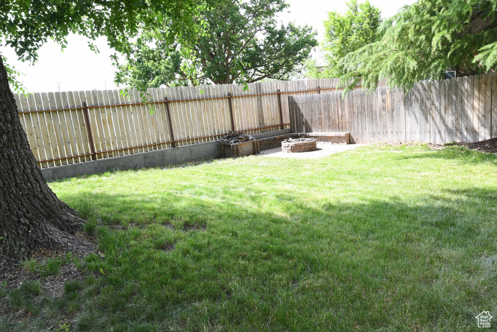 View of yard with a fire pit