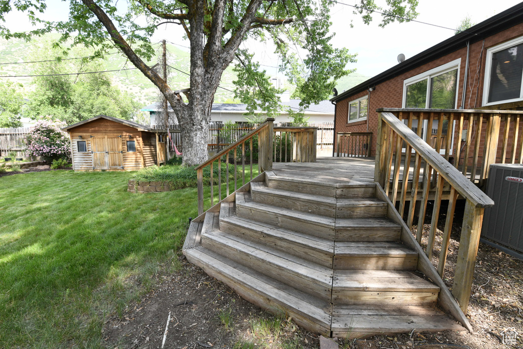 Deck featuring an outdoor structure and central AC unit