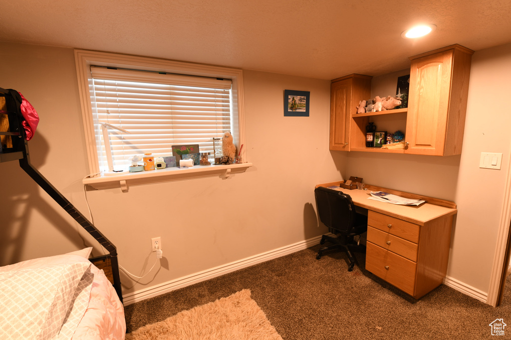 Home office featuring baseboards, carpet flooring, built in desk, and recessed lighting