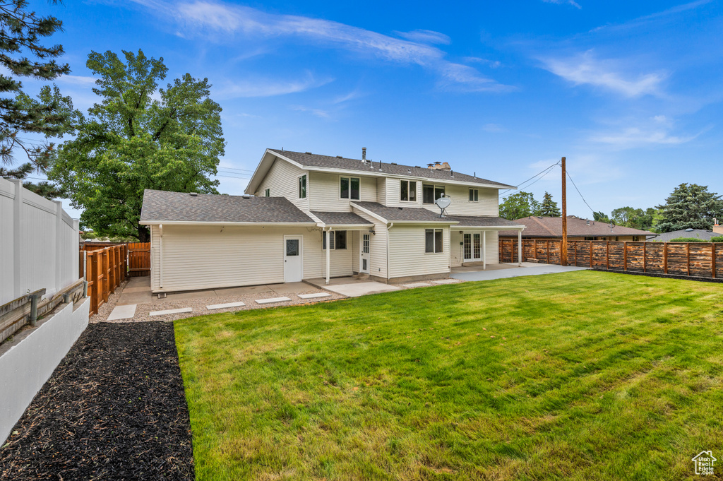 Back of house with a patio
