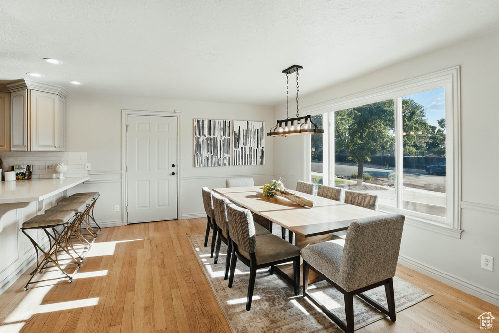 Dining area featuring light wood-style floors, recessed lighting, and baseboards