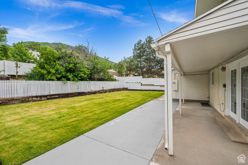 View of yard with a patio and a mountain view