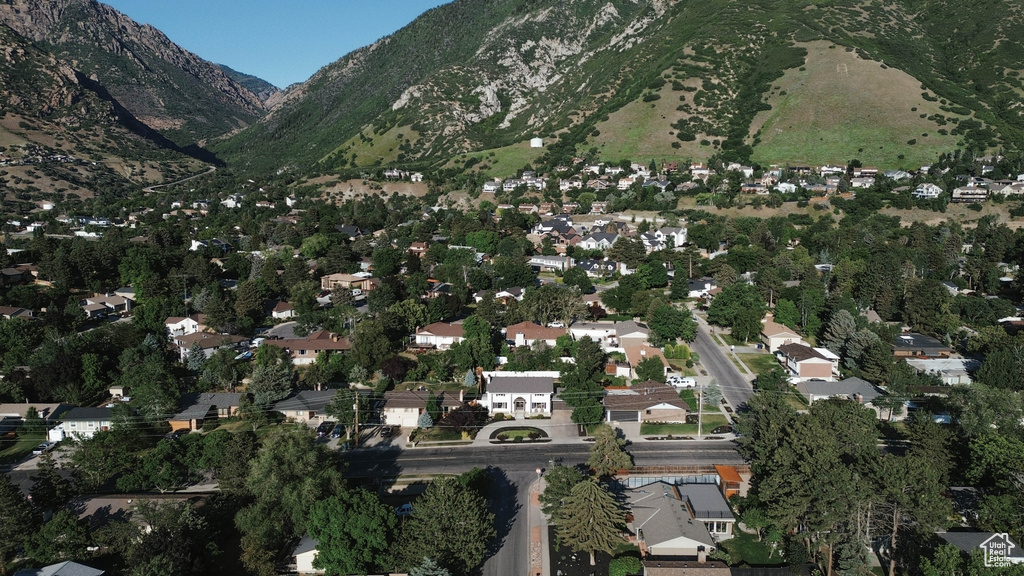 Aerial view of property and surrounding area with a mountain backdrop