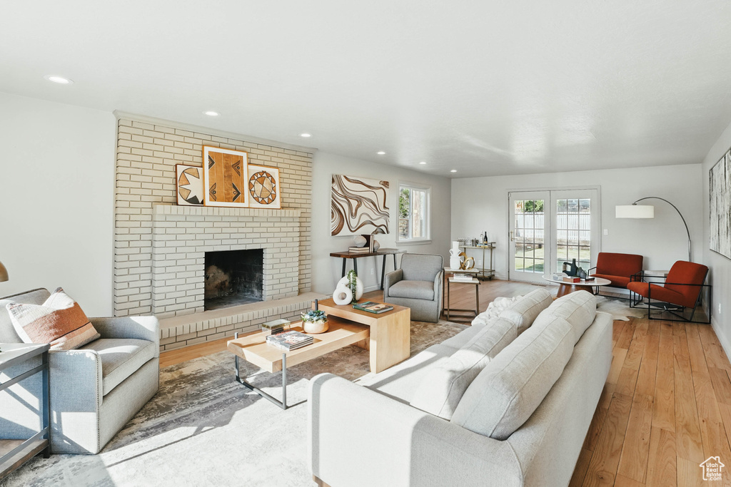 Living room featuring hardwood / wood-style floors, a fireplace, and recessed lighting