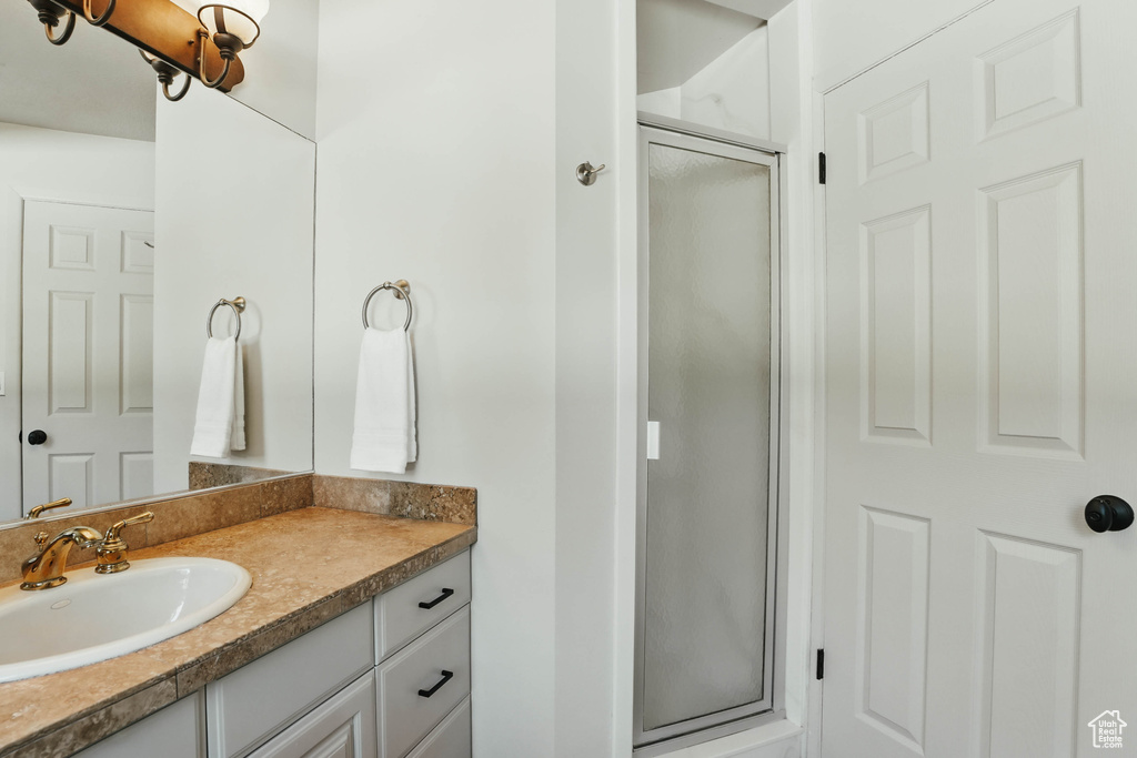 Full bath with a stall shower and vanity